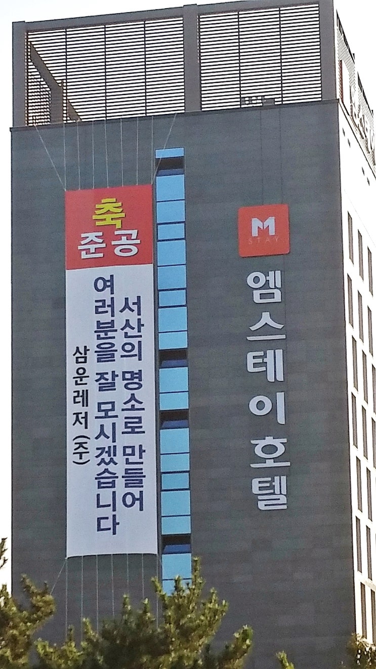  서산여행 단체 숙박시설  서산시 특급관광호텔 M-Stay 호텔 준공 현수막 과 서산 아파트 양우내안에 아파트 모습